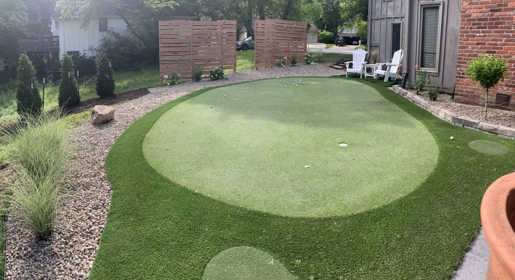 Backyard putting green with new landscaping