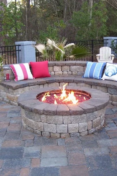 Stone fire pit with a curved seating wall