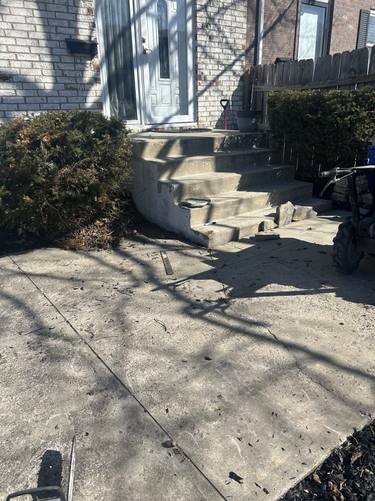 Before: the existing patio surface beside the steps.